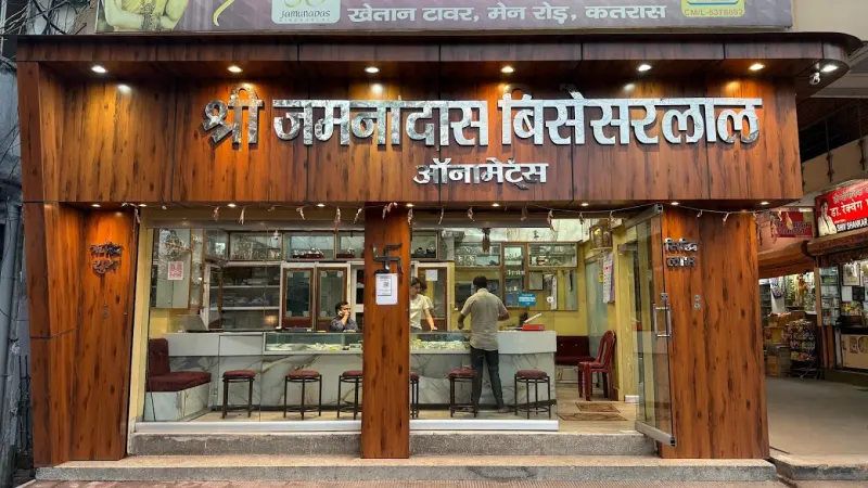 The JB Ornaments shop front on Main Road, Katras: wood panels and silver Hindi letters